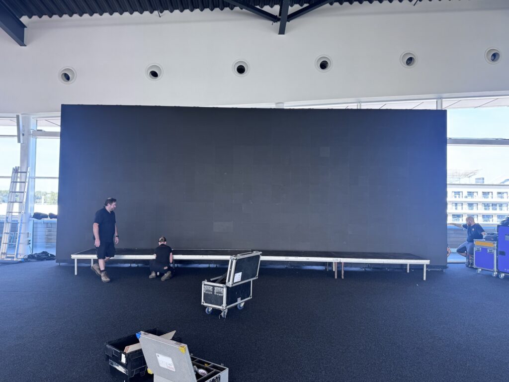 Crew building a 12-metre-wide by 4-metre-high LED video wall inside The Wing at Silverstone