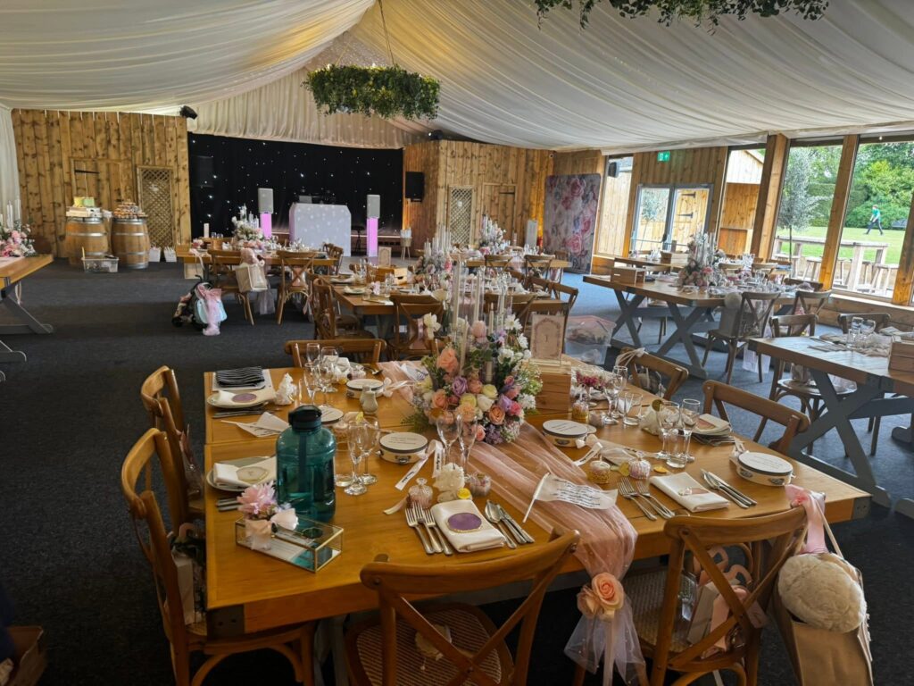 LA Events white wedding DJ booth and pink-lit speaker stands in the reception room at Plum Park Hotel, Towcester.